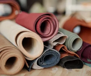 collection-of-rolled-suede-and-leather-of-various-colors-lying-on-wooden-table